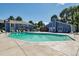 A large in-ground community pool with an adjacent clubhouse and lounge chairs at 7275 S Gaylord St # I09, Littleton, CO 80122