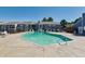 Community pool featuring a large in-ground pool with lounge chairs and a surrounding fence at 7275 S Gaylord St # I09, Littleton, CO 80122