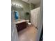 Bathroom featuring a single vanity, a plant shelf, and a shower/tub at 11207 Osage Cir # B, Northglenn, CO 80234
