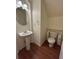 A well-lit half bathroom with modern fixtures and wood flooring at 11207 Osage Cir # B, Northglenn, CO 80234