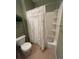 Cozy bathroom featuring a shower-tub combo with tile surround and a floral shower curtain at 11207 Osage Cir # B, Northglenn, CO 80234