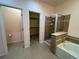Bathroom featuring a shower, soaking tub, and tile flooring, and a walk-in closet at 11207 Osage Cir # B, Northglenn, CO 80234