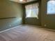 Bedroom featuring neutral walls and carpet with a window letting in ample natural light at 11207 Osage Cir # B, Northglenn, CO 80234