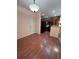 Dining area leading to the kitchen featuring wood floors and a neutral color scheme at 11207 Osage Cir # B, Northglenn, CO 80234