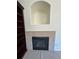 Close-up of the fireplace with tiled hearth, built-in niche and custom shelving at 11207 Osage Cir # B, Northglenn, CO 80234