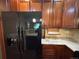 Spacious kitchen showcasing stainless steel appliances, wooden cabinetry, and well-lit countertop space at 11207 Osage Cir # B, Northglenn, CO 80234