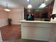 Open kitchen with wooden cabinets, breakfast bar, and seamless transition to dining area at 11207 Osage Cir # B, Northglenn, CO 80234