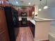 Well-appointed kitchen features dark appliances, wooden cabinets, and convenient breakfast bar at 11207 Osage Cir # B, Northglenn, CO 80234