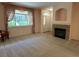 Bright living room with fireplace, plush carpet, large window, and elegant window treatments at 11207 Osage Cir # B, Northglenn, CO 80234