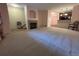 Open living area with neutral carpet, fireplace, and easy access to the kitchen at 11207 Osage Cir # B, Northglenn, CO 80234