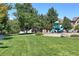 Community playground with a slide and climbing structure, set in a green park area at 11207 Osage Cir # B, Northglenn, CO 80234
