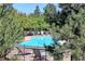 Community pool surrounded by trees and lounge chairs for relaxation at 11207 Osage Cir # B, Northglenn, CO 80234