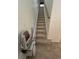 Carpeted staircase with stair lift for accessibility and safety at 11207 Osage Cir # B, Northglenn, CO 80234