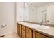 Double vanity bathroom with light wood cabinets and a large mirror at 18847 E Yale Cir # D, Aurora, CO 80013