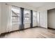 Bedroom with large windows and wood-look floors at 18847 E Yale Cir # D, Aurora, CO 80013