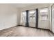 Well-lit bedroom with wood-look flooring and large windows at 18847 E Yale Cir # D, Aurora, CO 80013