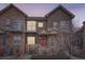 Two-story townhome with stone accents and a red door at 18847 E Yale Cir # D, Aurora, CO 80013