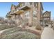 Stone clad townhome boasts metal balconies, red door, and xeriscaped front yard at 18847 E Yale Cir # D, Aurora, CO 80013