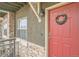 Red front door with a wreath, welcoming entryway at 18847 E Yale Cir # D, Aurora, CO 80013