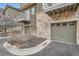 Attached garage with green door and stone accents at 18847 E Yale Cir # D, Aurora, CO 80013