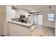 Bright kitchen with white cabinetry and stainless steel appliances leads to dining area at 18847 E Yale Cir # D, Aurora, CO 80013