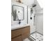Modern bathroom with stylish black fixtures, a walk-in shower and a wooden vanity at 840 S Pennsylvania St, Denver, CO 80209