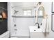 Modern bathroom featuring a shower-tub combo and a floating vanity with a black faucet at 840 S Pennsylvania St, Denver, CO 80209