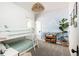 Cozy bedroom featuring bunk beds, a blue accent wall, and a wicker pendant light at 840 S Pennsylvania St, Denver, CO 80209