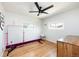 Bright bedroom with hardwood floors, ceiling fan, and natural light at 840 S Pennsylvania St, Denver, CO 80209