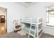 A bedroom with white bunk beds, a nightstand, and a window at 840 S Pennsylvania St, Denver, CO 80209