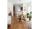 Bright dining area with hardwood floors, modern chandelier, and open view into the kitchen at 840 S Pennsylvania St, Denver, CO 80209