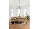 Bright dining area featuring a modern chandelier, light wood table and a cowhide rug at 840 S Pennsylvania St, Denver, CO 80209