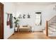 Stylish entryway with hardwood floors, a cozy bench, and decorative wall art, creating an inviting space at 840 S Pennsylvania St, Denver, CO 80209