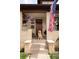 Charming front porch with brick pillars, hanging flower baskets, and a friendly golden retriever at 840 S Pennsylvania St, Denver, CO 80209