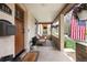Inviting covered front porch with seating, plants, and an American flag, offering a charming welcome at 840 S Pennsylvania St, Denver, CO 80209