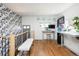 Hallway featuring a white bench, hardwood floors and black and white accent wall at 840 S Pennsylvania St, Denver, CO 80209