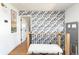 Hallway featuring hardwood floors, a bench and a patterned accent wall at 840 S Pennsylvania St, Denver, CO 80209