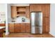 Kitchen featuring stainless steel refrigerator, wooden cabinets and white countertops at 840 S Pennsylvania St, Denver, CO 80209