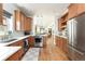 Bright kitchen with stainless steel appliances, wood cabinets and an eat-in area at 840 S Pennsylvania St, Denver, CO 80209