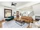 Bright living room with hardwood floors, a large leather sectional sofa, and ample natural light at 840 S Pennsylvania St, Denver, CO 80209