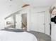 Bright bedroom featuring soft carpet, a decorative rug, and access to a staircase at 840 S Pennsylvania St, Denver, CO 80209