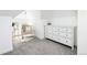 Bright bedroom features soft carpet, a comfortable chair and a white dresser at 840 S Pennsylvania St, Denver, CO 80209
