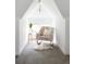 Bright sitting area features soft carpet, a comfortable rocking chair and natural light at 840 S Pennsylvania St, Denver, CO 80209
