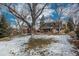 Large backyard with deck and partial snow coverage at 6941 S Poplar Way, Centennial, CO 80112