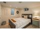 Basement bedroom with double bed, nightstand and window at 6941 S Poplar Way, Centennial, CO 80112