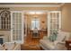 Bright dining room with hardwood floors and french doors at 6941 S Poplar Way, Centennial, CO 80112