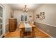 Dining room features hardwood floors and a farmhouse table at 6941 S Poplar Way, Centennial, CO 80112