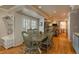 Dining room with hardwood floors, green table and chairs, and access to the backyard at 6941 S Poplar Way, Centennial, CO 80112