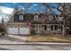 Two-story house with attached two-car garage, landscaping, and a brick facade at 6941 S Poplar Way, Centennial, CO 80112