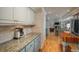 Bright kitchen with granite counters and hardwood floors at 6941 S Poplar Way, Centennial, CO 80112